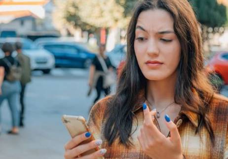Woman suspiciously looking at her phone