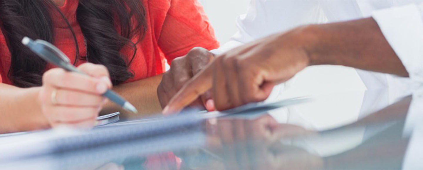 Two people filling out forms