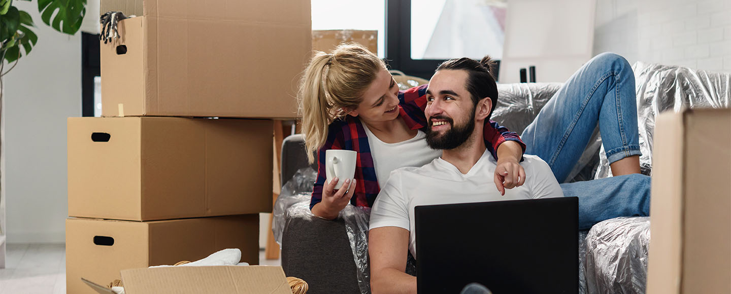 Couple surrounded by boxes in their new home