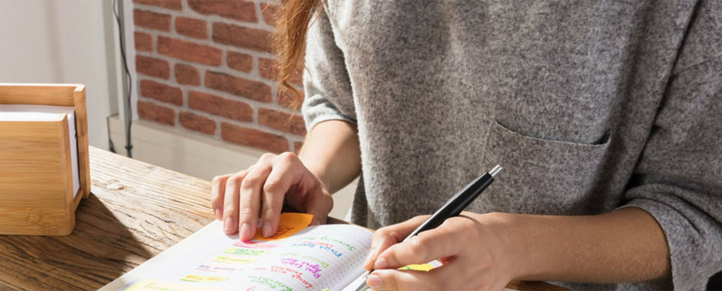Woman writing in notebook